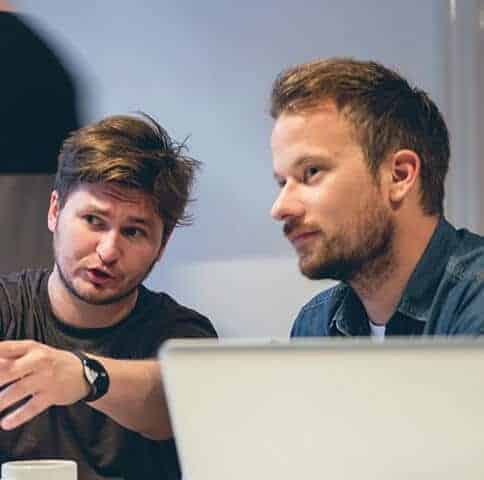 IT contractors discussing work on screen