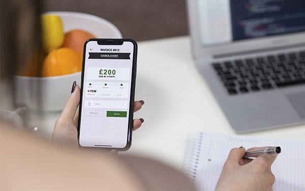 Freelancer using invoicing app on iPhone