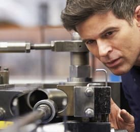 Engineering insurance - close up of male engineer working with equipment.