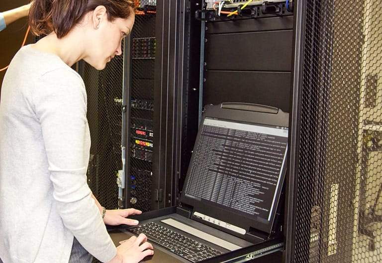 IT professional overseeing maintenance to a server.