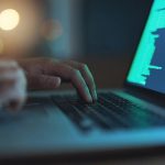 a hacker breaks into a digital system on a laptop